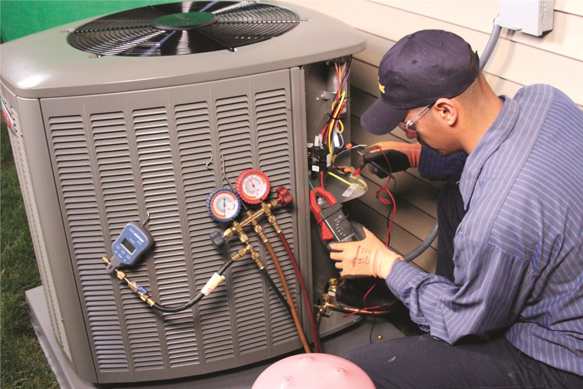 HVAC technician testing an outdoor air conditioning unit in Apache Junction