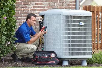 HVAC technician inspecting an outdoor air conditioning unit in Apache Junction, AZ
