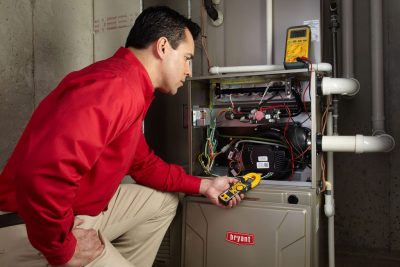 Heating and air conditioning technician servicing an indoor furnace in Apache Junction, AZ